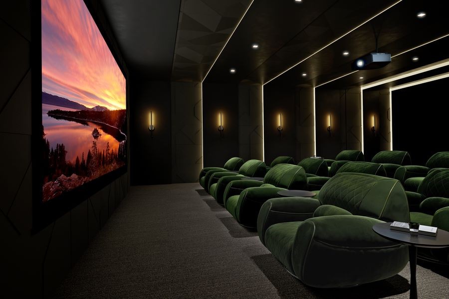 A home theater with a large screen, a Sony projector, and green plush theater seating.