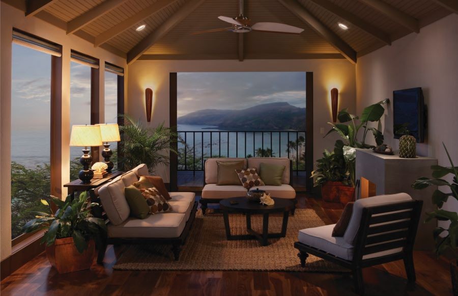A well-lit living area with floor-to-ceiling windows on the ocean.