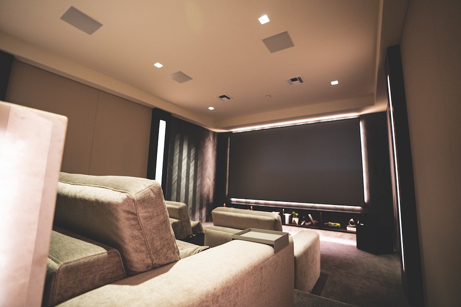 A home theater space uses surround sound speakers from Sonance.